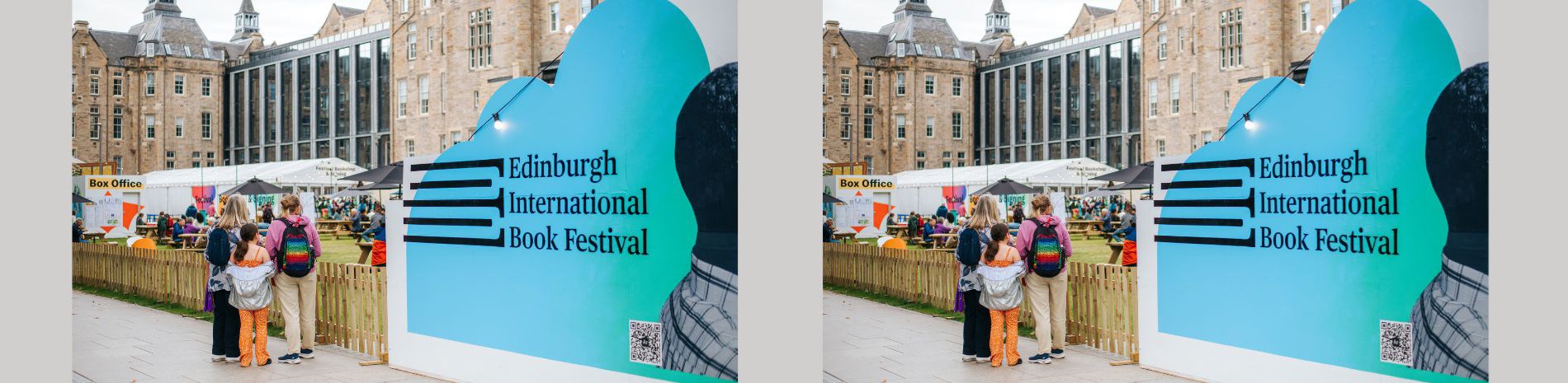 A group of people standing next to a big sign for the Edinburgh International Book Festival.