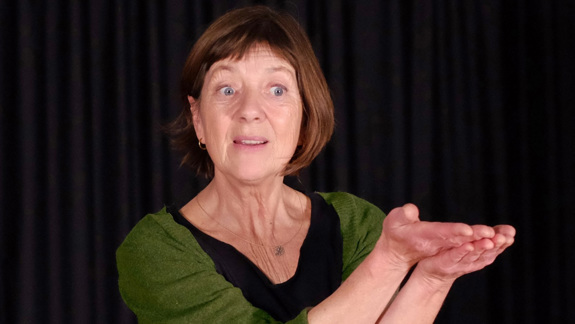 A photo of Suse Weisse holding her hands out.