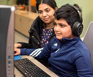 Child and parent at computer