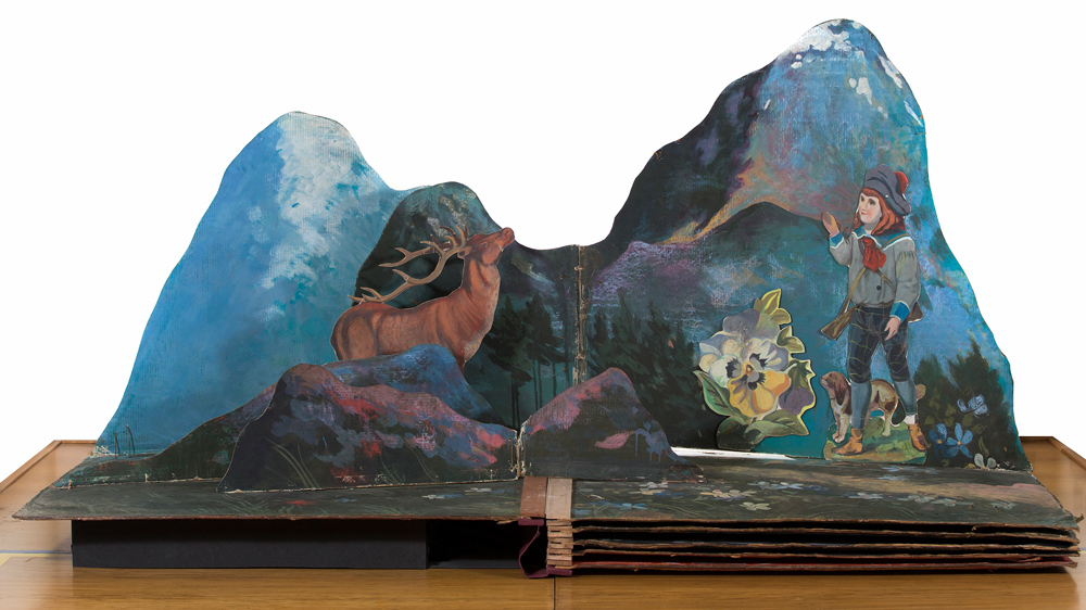 Stage set one showing a landscape scene with a stag and a child with a dog.
