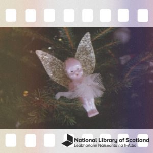 A fairy ornament hanging on a Christmas tree. The image has been made to look like part of a film strip. There is a National Library of Scotland logo in the bottom right.